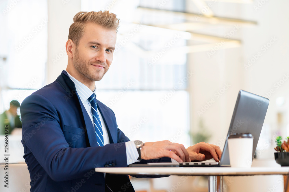 smart caucasian businessman in suit working with laptop and smartphone communication with happiness and focus successsful business ideas concept smart caucasian businessman in suit working with laptop and smartphone communication with happiness and focus successsful business ideas concept