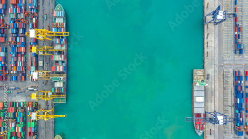 Container ship in export and import business logistics and transportation. Cargo and container box shipping to harbor by crane. Water transport International. Aerial view and top view.