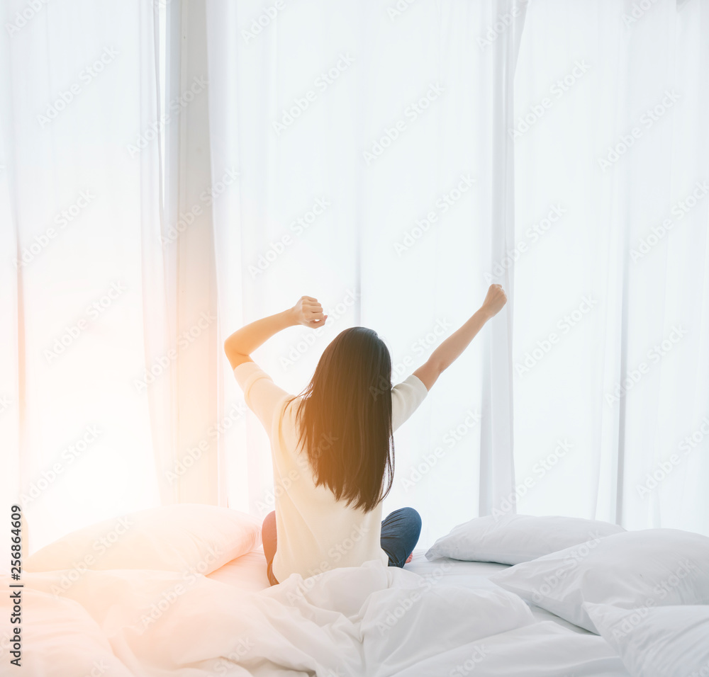 white dress asian beautiful woman stretching morning wake up bedroom with white curtain background lifestyle home concept - obrazy, fototapety, plakaty 