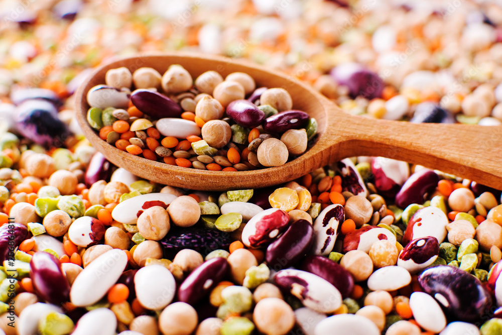 collection set of beans, legumes, peas, lentils on wooden spoons on legumes background collection set of beans, legumes, peas, lentils on wooden spoons on legumes background