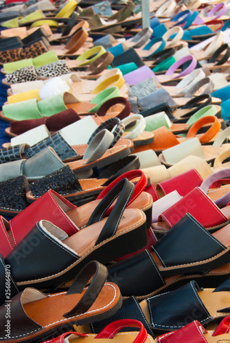 Colored Minorca shoes on a table of a market