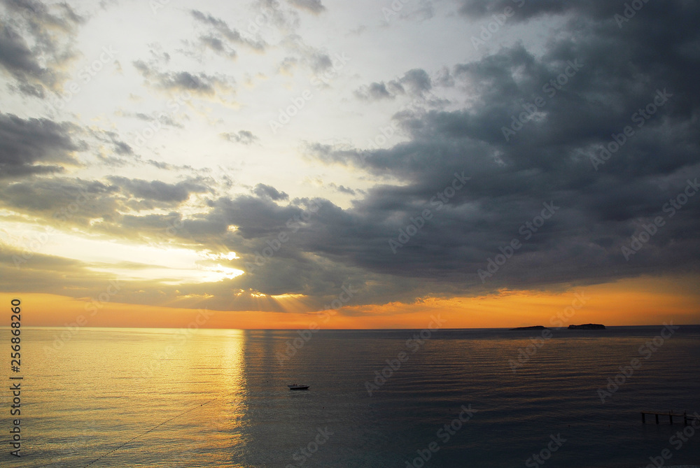 Sunset on the sea, half bright, half dark Sunset on the sea, half bright, half dark
