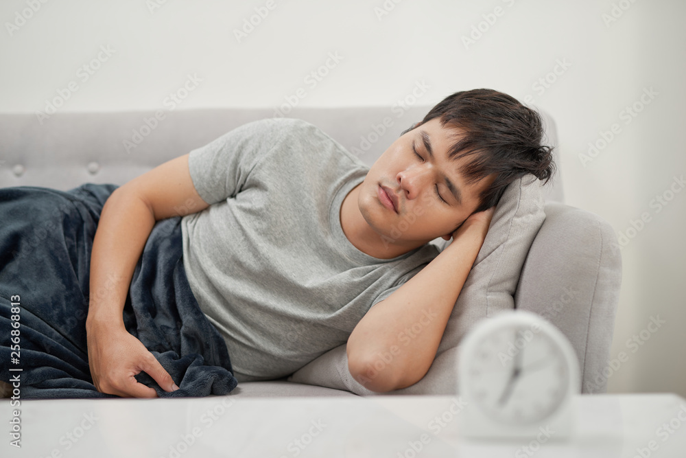 Sick man lying on the couch Sick man lying on the couch