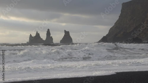 Rock spire of Reynisdrangur, coast of Reynisfjara close to Vik, Iceland, Europe photo