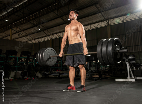 Young sport man doing deadlift exercise with heavy weigth barbell at gym - fitness, healthy lifestyle concept - Image