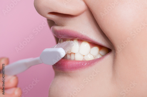 Beautiful young woman smiling with toothbrush