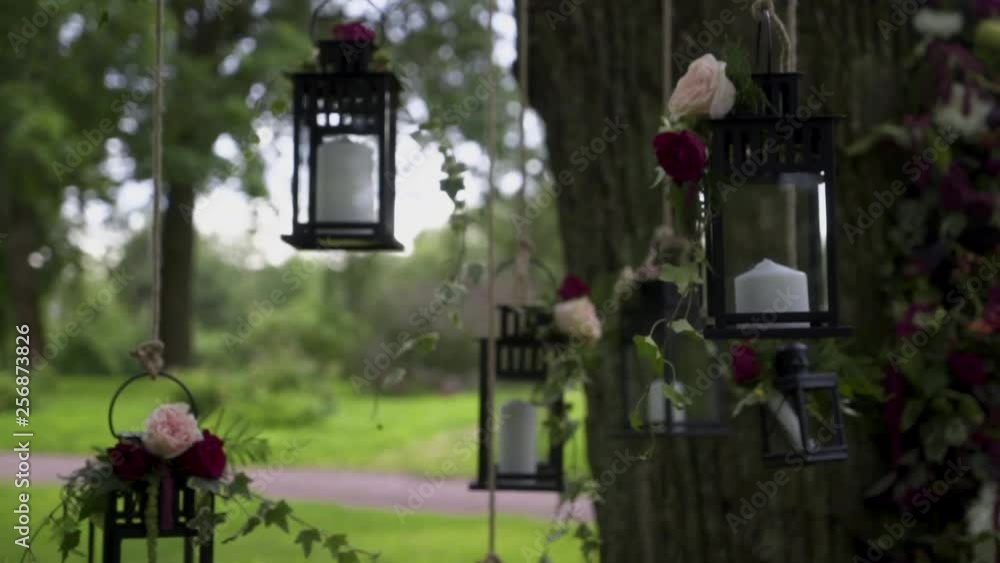 Wedding decor with white candles, photo area by a tree in the park Wedding decor with white candles, photo area by a tree in the park