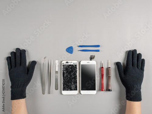 Technician or engineer prepairing to repair and replace new screen broken and cracked screen smartphone prepairing on desk with copy space photo