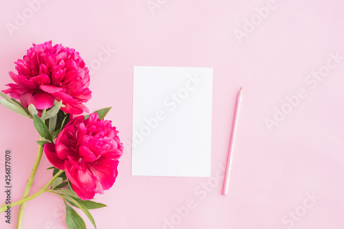 Mockup white greeting card with red peonies on a pink background