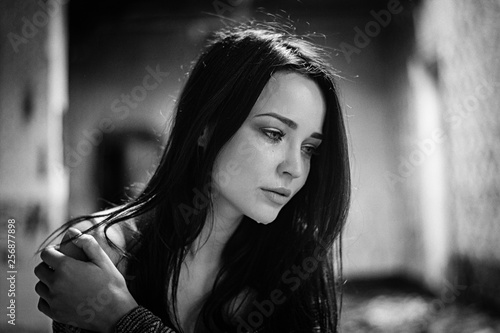 The girl suffers and cries. Portrait. Black and white