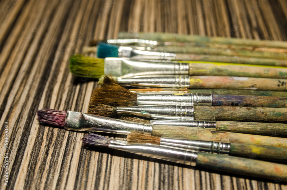 Fototapeta premium Paint brushes on the wooden background