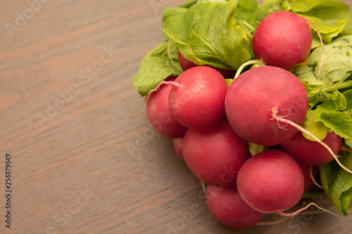 bunch of radishes on wooden table
