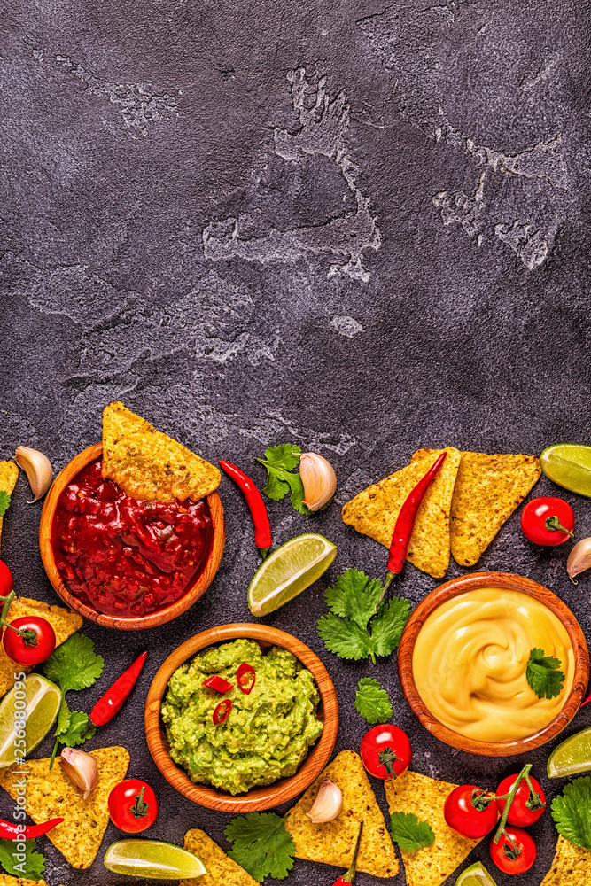Mexican food background: guacamole, salsa, cheesy sauces