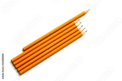 Several wooden graphite pencils isolated on a white background. Business leadership, teamwork and courage concept.