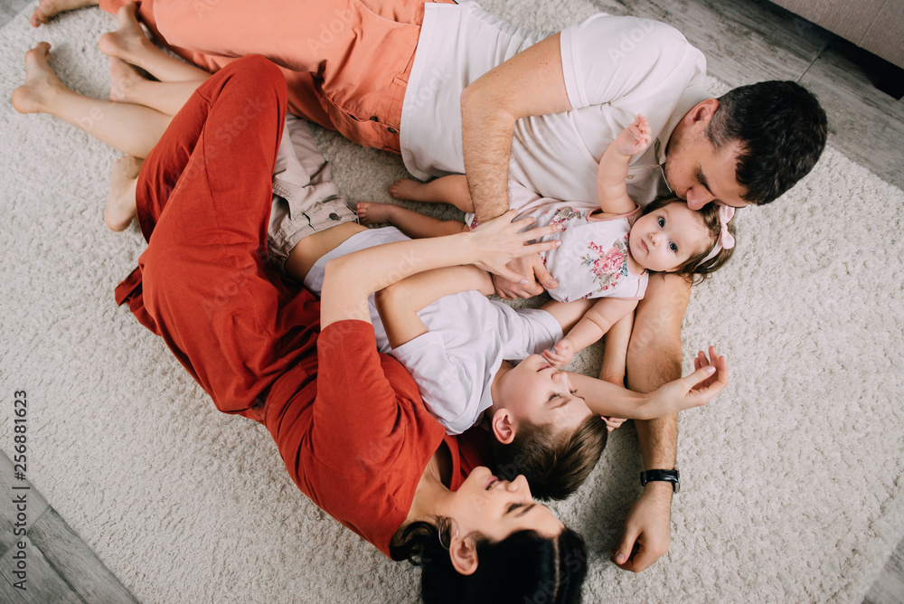 Cheerful portrait of happy young family at home