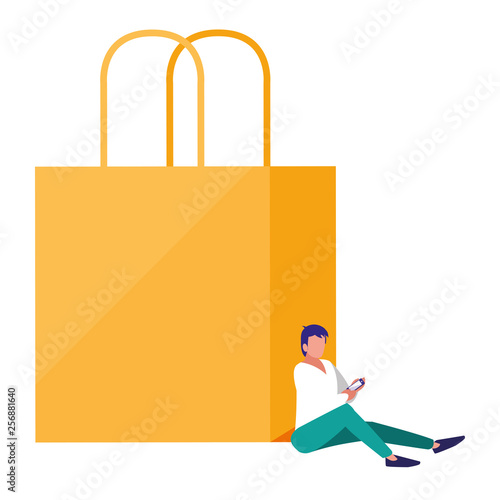 young man using smartphone with shopping bag