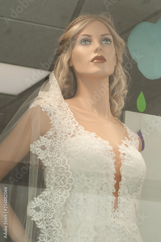 closeup of wedding dress on mannequin in fashion store showroom