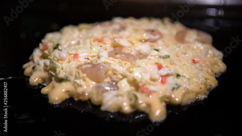 Okonomiyaki japanese food. Cooking Monjayaki fried in restaurant of Japan. photo