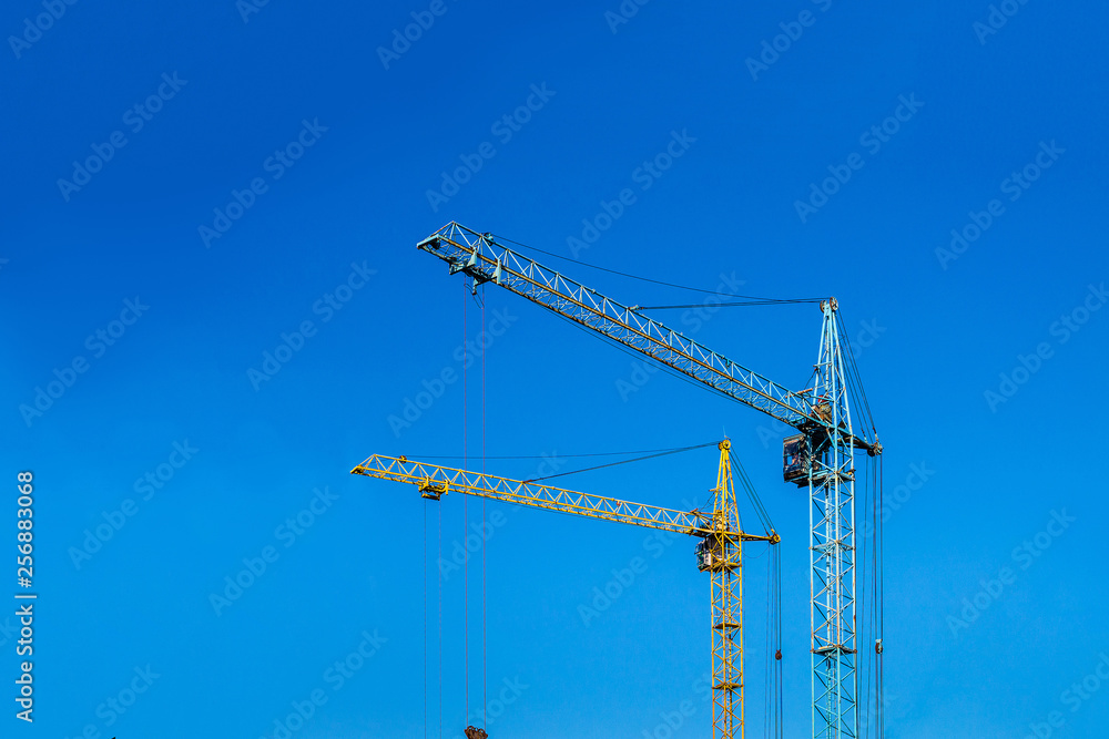 Two cranes against the blue sky. Two cranes against the blue sky.