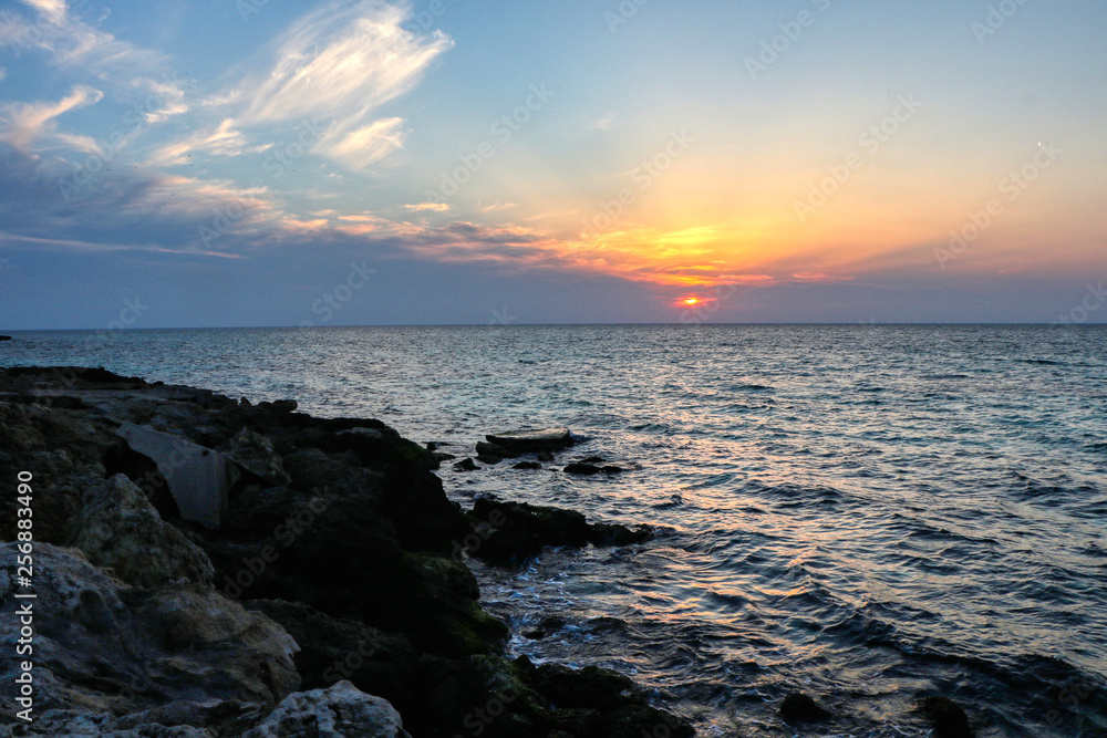 First spring sunset at the sea of Taranto, Puglia, Italy