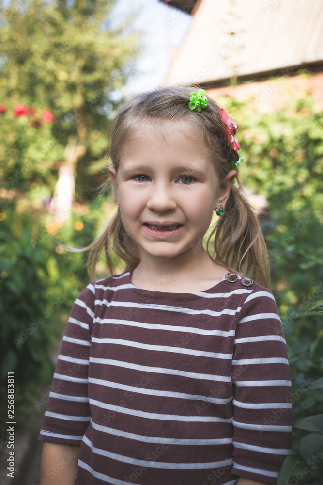 Child with a dental orthodontic device and without one tooth Child with a dental orthodontic device and without one tooth