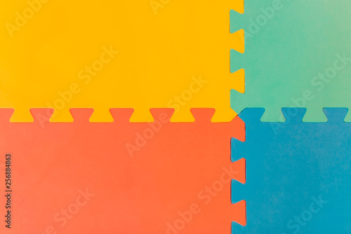 Foam flooring tiles / mats inside a play room, kindergarten school or gym. Potential use as a colorful background with copy space. photo