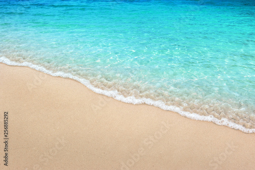 Soft blue ocean wave on clean sandy beach summer concept background