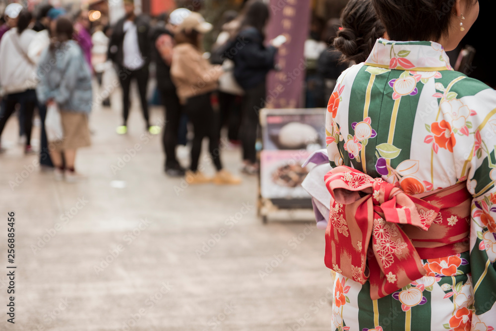 TOKYO,JAPAN - February 20, 2019 : People are wearing kimono while travel in Senso-ji Temple , famous temple in Tokyo,Japan.