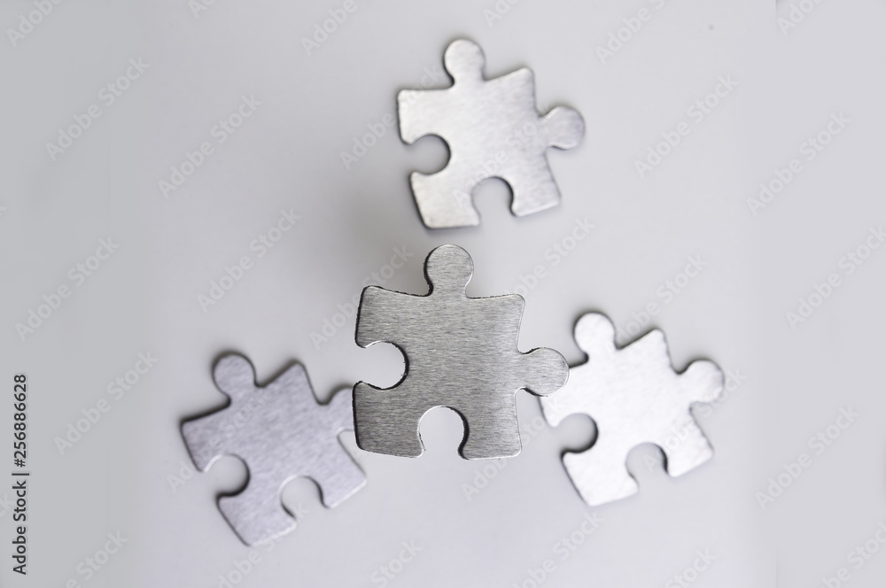 Obraz premium metal puzzle on a white background