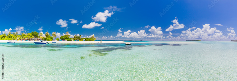 Amazing Maldives island panorama. Beautiful beach scene with palm trees and perfect blue sea water. Relaxing and exotic tropical landscape view. Luxury summer vacation and holiday banner concept 