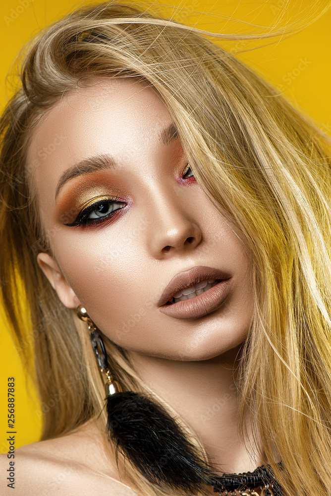 Blonde with great makeup. Yellow background. Portrait Blonde with great makeup. Yellow background. Portrait