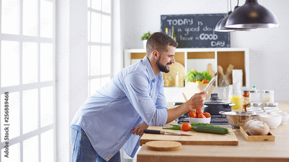 Smiling and confident chef standing in large kitchen Smiling and confident chef standing in large kitchen