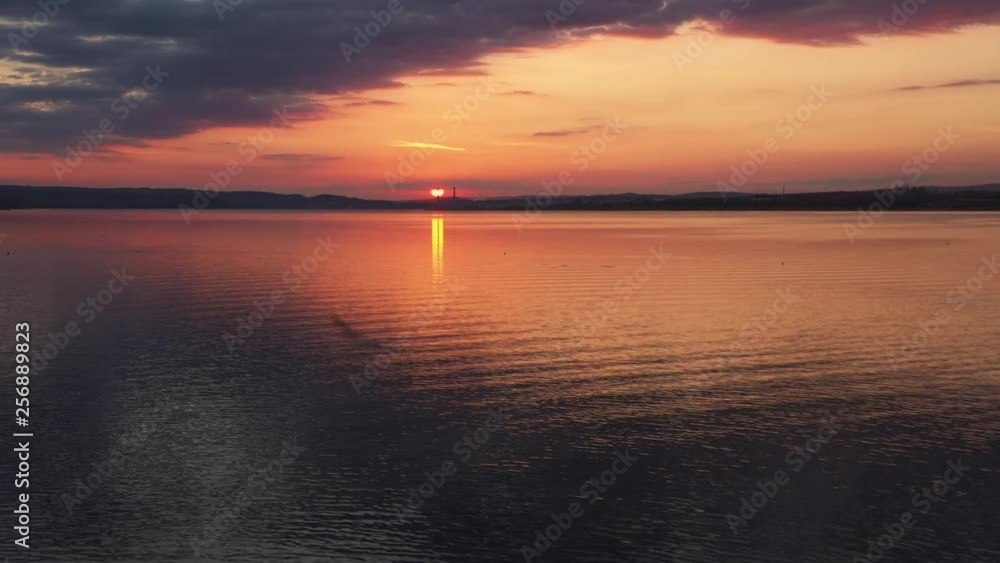 Sea in light of golden sunset of day aerial view of drone slide above. Small waves on sea. Sunny sunset over the sea. Sun way. The sky with clouds. Horizon. Nature Sea in light of golden sunset of day aerial view of drone slide above. Small waves on sea. Sunny sunset over the sea. Sun way. The sky with clouds. Horizon. Nature