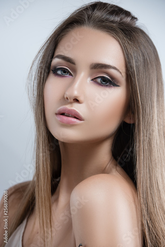Brunette with expressive eye and lip makeup. Clean, radiant skin.