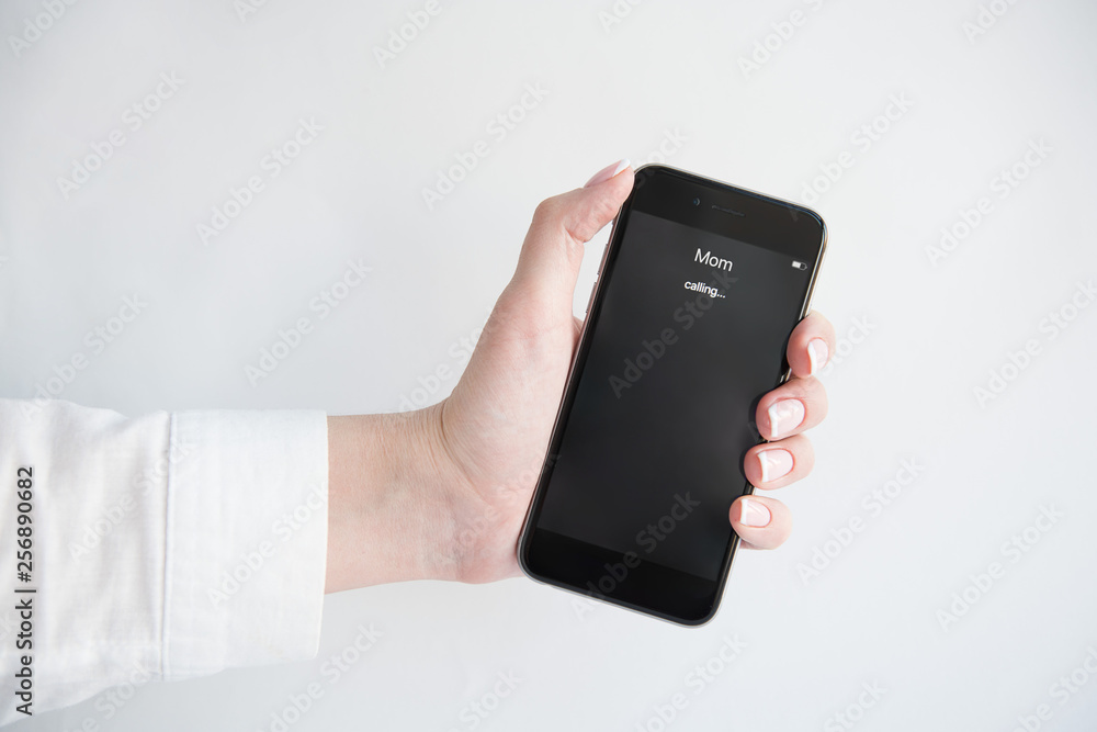 Female hand holding a smartphone. Smartphone Incoming mother(mom) calls. Mom's Incoming Call On Display. Family concept. Female hand holding a smartphone. Smartphone Incoming mother(mom) calls. Mom's Incoming Call On Display. Family concept.