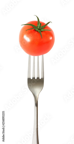 Tomato whole one impaled on a fork isolated on white background with clipping path.