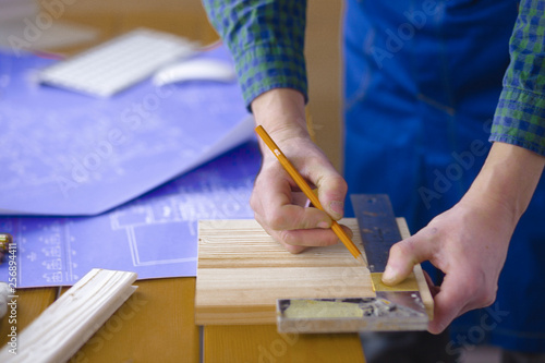 Engineer carpenter working on laptop and sketching project