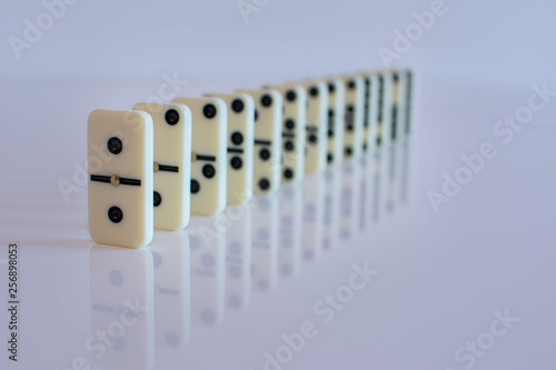 domino tiles in a row on white background in Low key