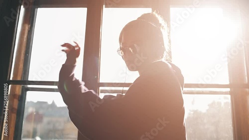 Girl wearing headphones grooving with the music photo