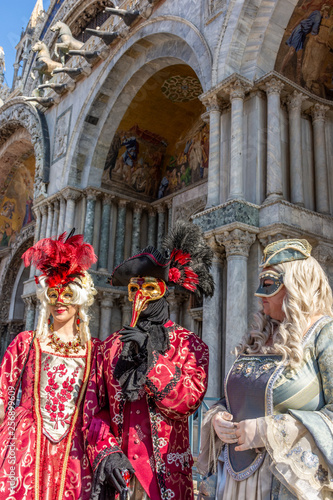 Italy, Venice, carnival, 2019, people with beautiful masks walk around Piazza San Marco, in the streets and canals of the city, posing for photographers and tourists, with colorful clothes.