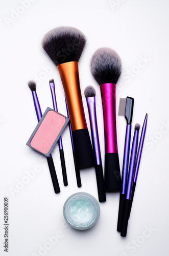Close-up top view of make up brushes and blush on a white table. Make-up artist set concept