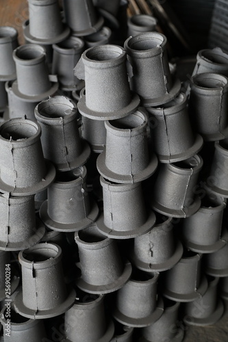 Stocks Of Unfinished Gray Hydrant Caps Piled Up In Sewerage Products Warehouse Close Up