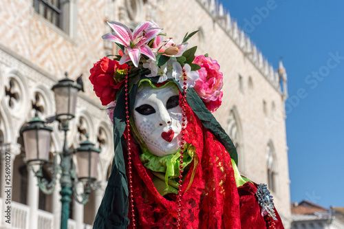 Italy, Venice, carnival, 2019, people with beautiful masks walk around Piazza San Marco, in the streets and canals of the city, posing for photographers and tourists, with colorful clothes.