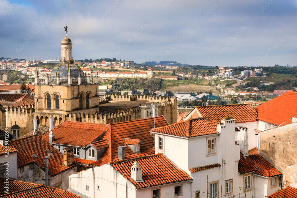 Panorama of the city center of Coimbra in Portugal with a catholic ancient cathedral Se velia and red tile roofs on a spring day