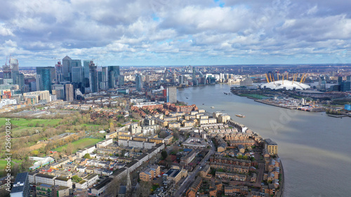 Aerial bird's eye view photo taken by drone of Canary Wharf skyline as seen from river Thames with beautiful cloudy sky, Isle of Dogs, London, United Kingdom © aerial-drone