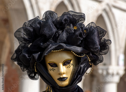 Italy, Venice, carnival, 2019, masked people roam the city, posing for photographers and tourists, with beautiful clothes.