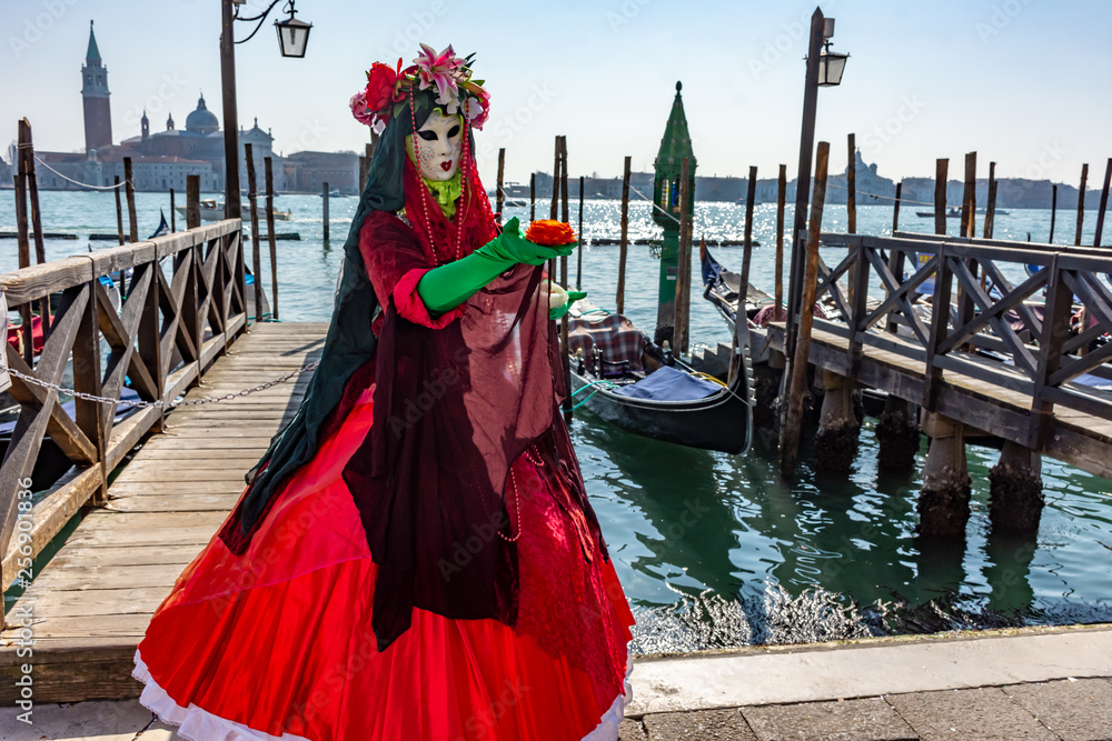 Italy, Venice, carnival, 2019, masked people roam the city, posing for photographers and tourists, with beautiful clothes.