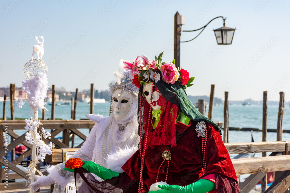 Italy, Venice, carnival, 2019, masked people roam the city, posing for photographers and tourists, with beautiful clothes.