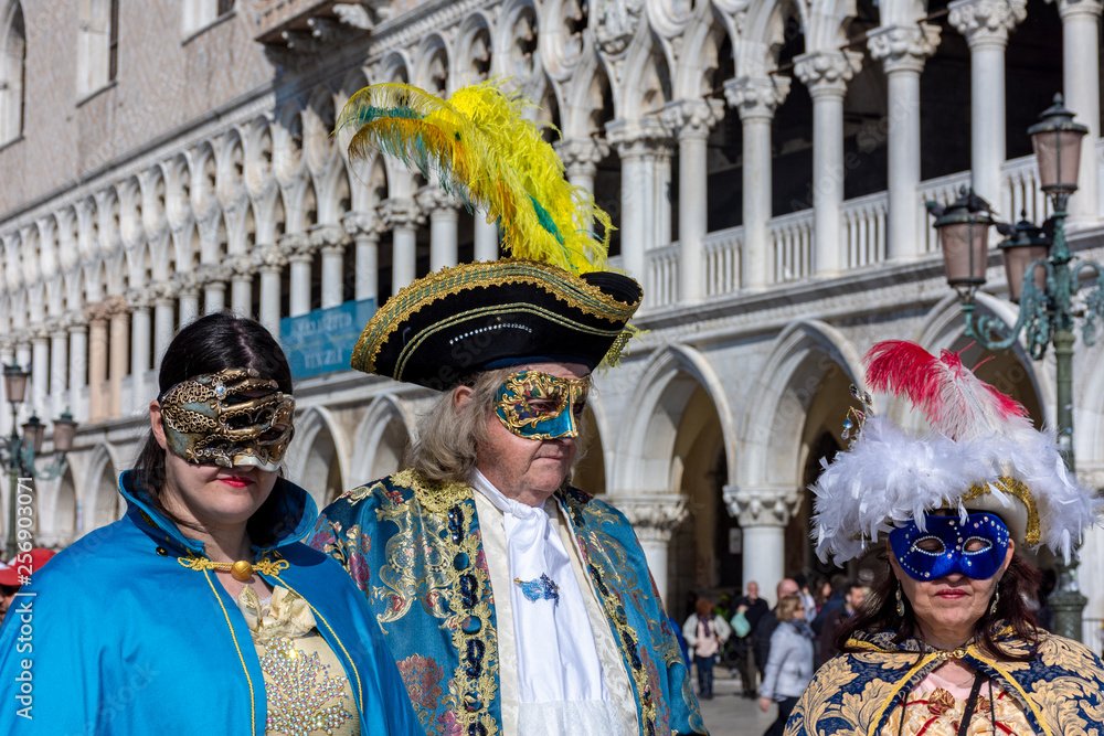 Italy, Venice, carnival, 2019, masked people roam the city, posing for photographers and tourists, with beautiful clothes.