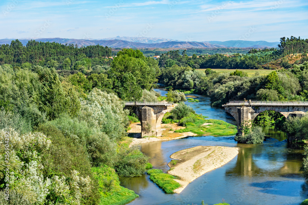 Beautiful river landscape with a destroyed old bridge.